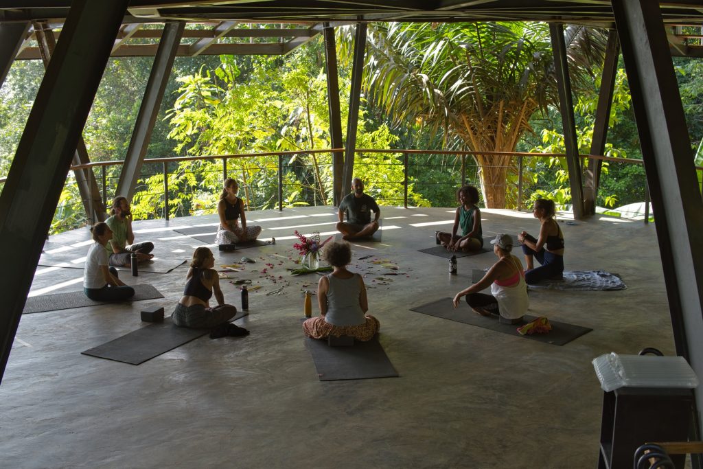 Students practicing yoga in La Loma's open air jungle yoga studio