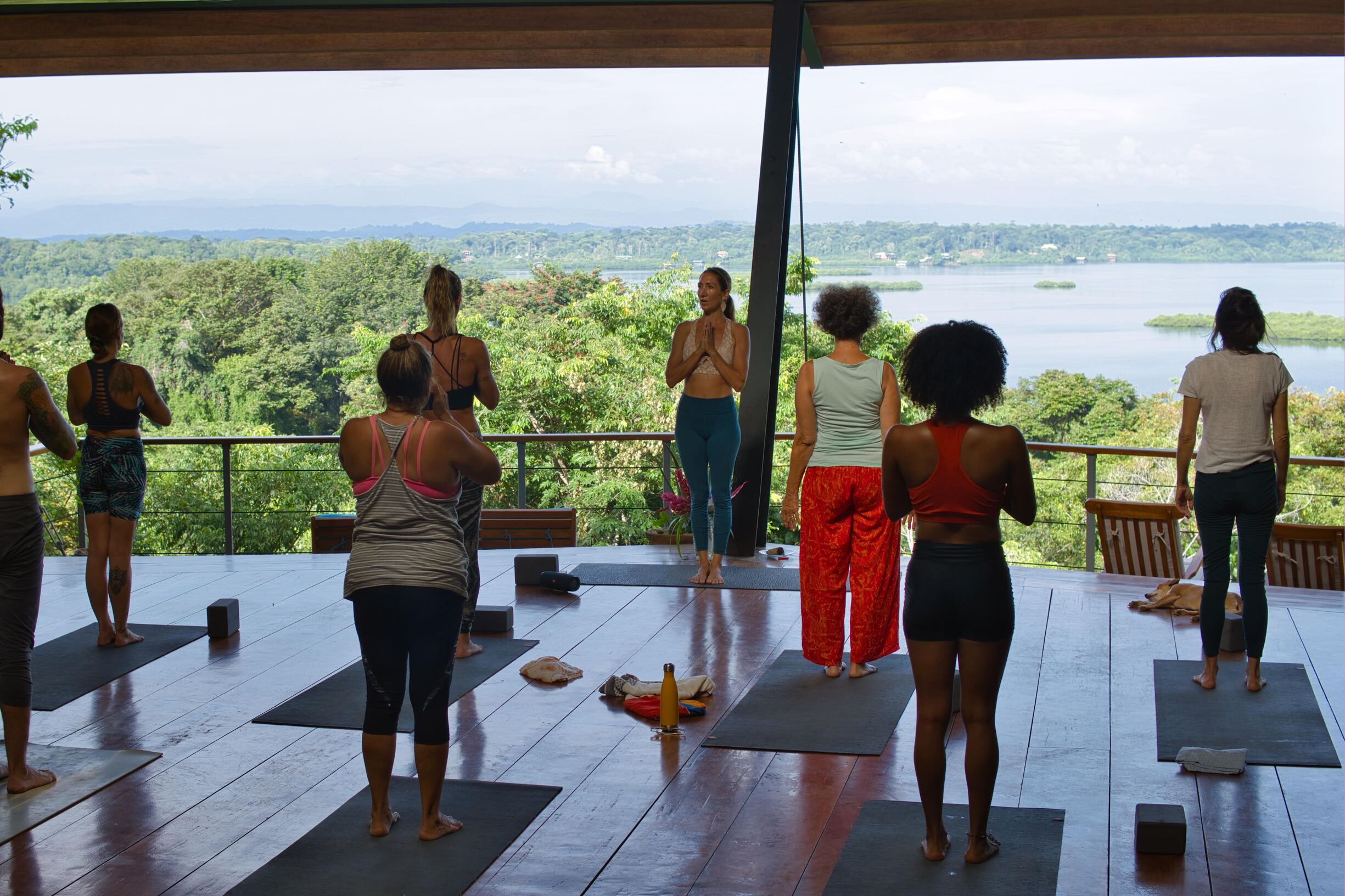 Students doing yoga overlooking the bay at La Loma Jungle Lodge