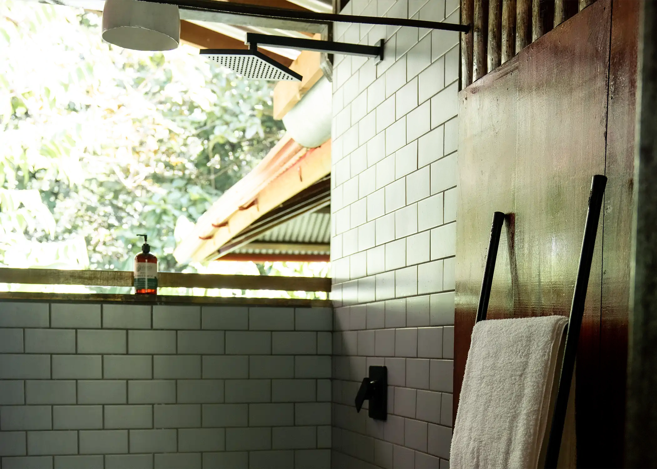 Open-air hot shower with jungle views at Cacao Farm House