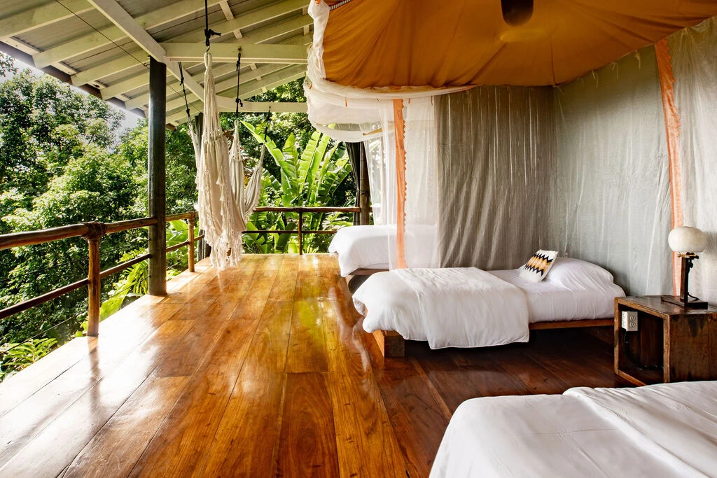 Family Treetop Bungalow interior with multiple beds and jungle views