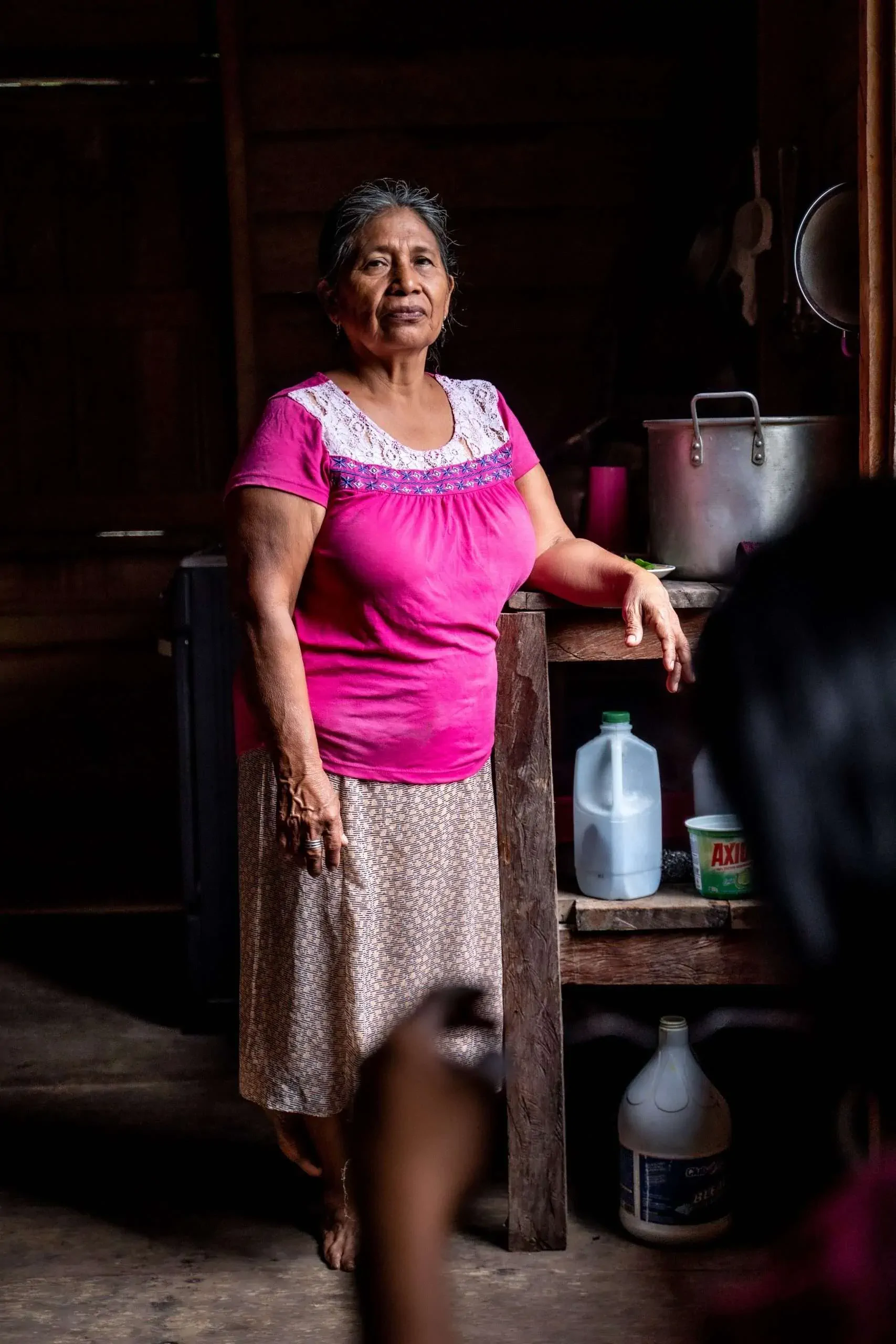 Ngäbe-Buglé community woman in traditional pink dress at home in Panama