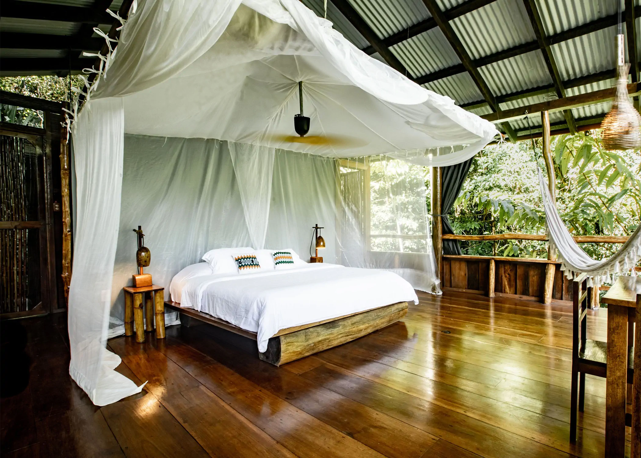 Luxury king bed with mosquito net in jungle treetop bungalow
