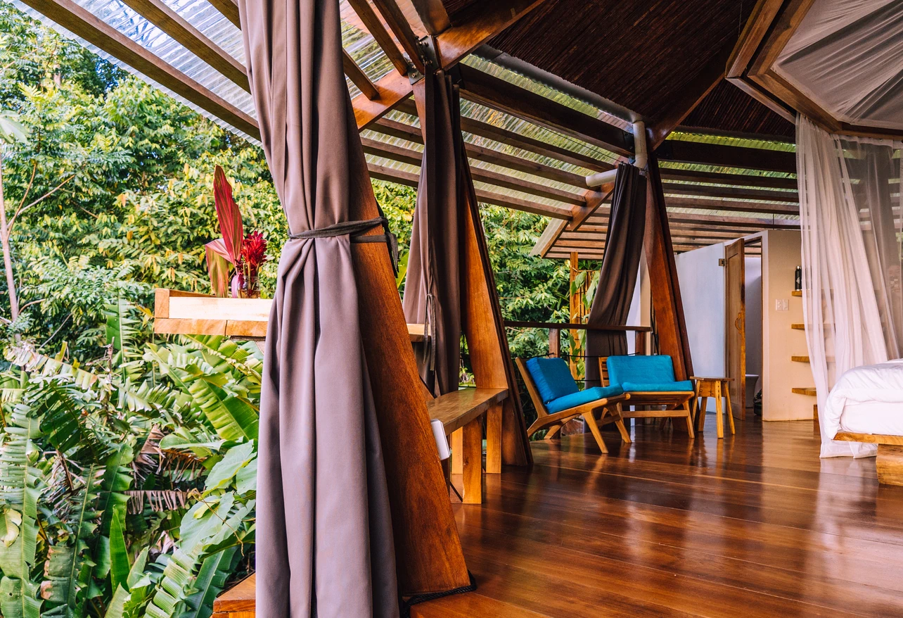 Rainforest Queen Bungalow covered terrace seating area overlooking tropical rainforest