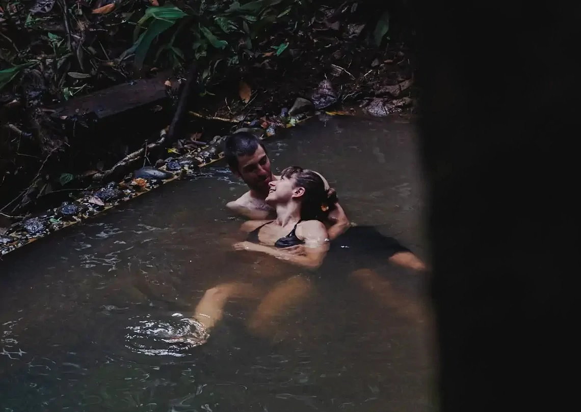 Natural spring-fed rock pool surrounded by rainforest at La Loma, Isla Bastimentos, Panama